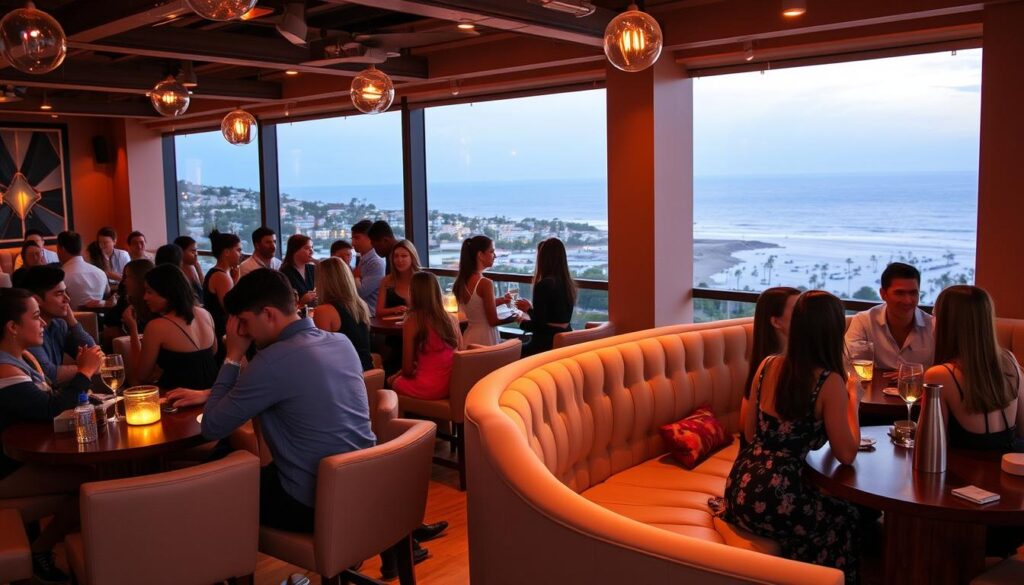 Upcoming speed dating event in Isla Vista, California, with a vibrant and youthful atmosphere. A modern, stylish venue with warm lighting and a mix of chic tables and plush seating for intimate conversations. The foreground features a diverse group of young adults, elegantly dressed, engaged in lively discussions, while the background showcases the picturesque coastal landscape of Isla Vista, including a glimpse of the Pacific Ocean in the distance. The scene conveys a sense of excitement, connection, and the promise of new relationships being forged.